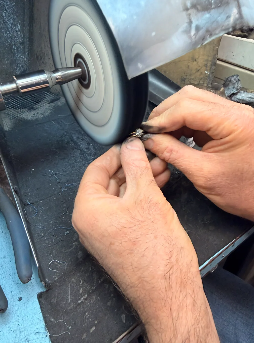 Jeweler polishing a ring at the workbench